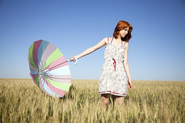 Girl with umbrella at field — Stock Photo, Image