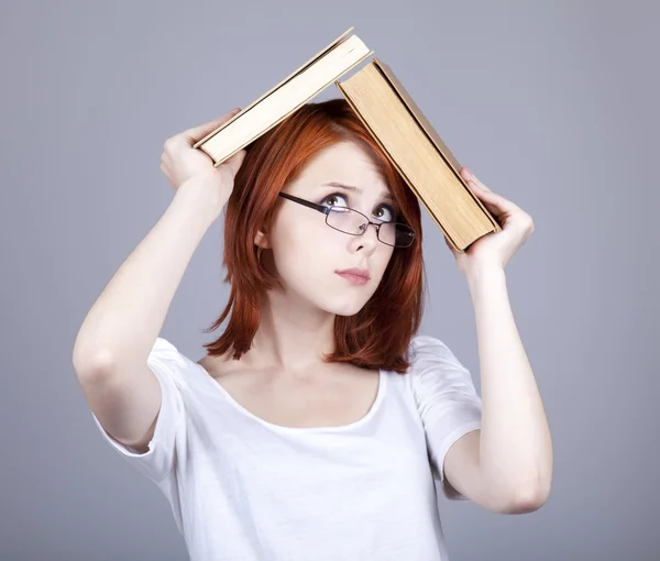 Rödhårig affärskvinna hålla böcker i händerna. — Stockfoto