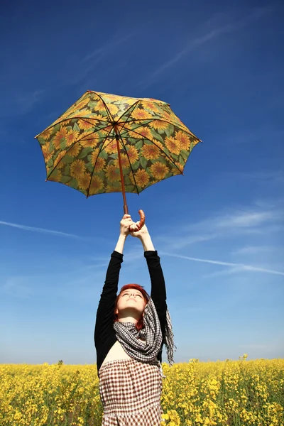 Young woman with umbrella at rape field. — Stock Photo, Image