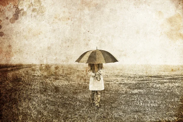 Girl with umbrella at field. Photo in old image style. — Stock Photo, Image