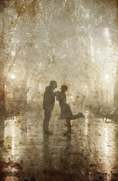 Couple walking at alley in night lights. Photo in vintage yellow style. — Stock Photo, Image