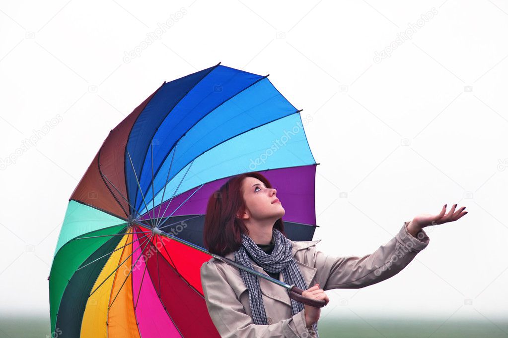 Girl with umbrella on field.