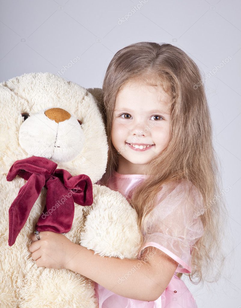 Little girl embraces bear cub. — Stock Photo © massonforstock #3492138