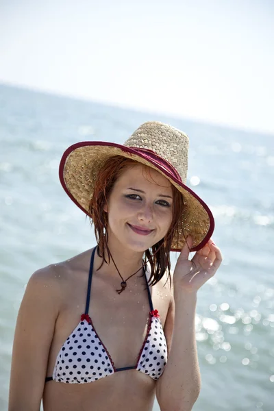 Sexy young red-haired girl in cap on the beach. — Stock Photo, Image