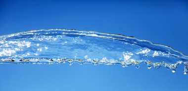 Water splash isolated on blue. clipart