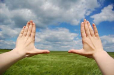 Frame made of hands at wheat field clipart