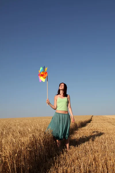 Girl with wind turbine at wheat field — Stock Photo, Image