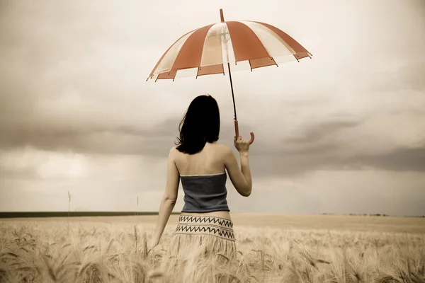Girl with umbrella at field in retro style — Stock Photo, Image