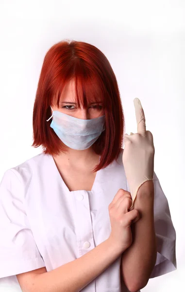 Rødhåret sygeplejerske med handske - Stock-foto