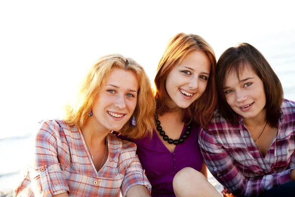 Portrait of three beautiful girls. With counter light on backgro — Stock Photo, Image
