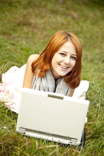 Chica de la moda joven con cuaderno acostado en la hierba verde —  Fotos de Stock