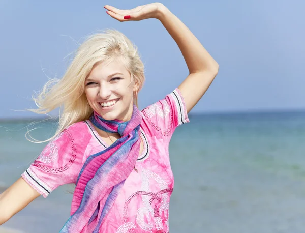 Young blonde girl in pink on the beach. — Stock Photo, Image