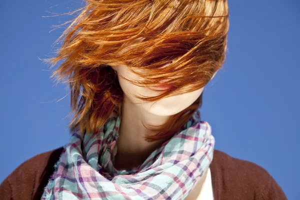 Portret rudowłosa dziewczyna z szalikiem na niebieskim tle. — Zdjęcie stockowe