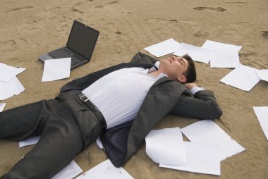 Businessman relax on the beach clipart