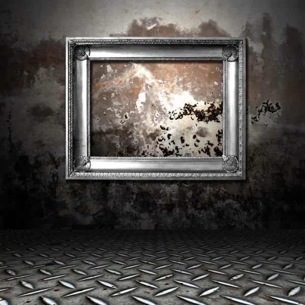 Silver frame in a dark grungy room — Stock Photo, Image