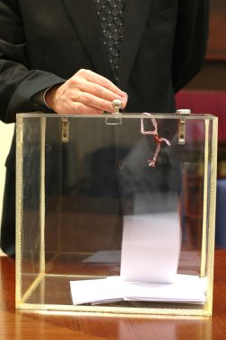 Ballot box and hand putting a ballot in clipart