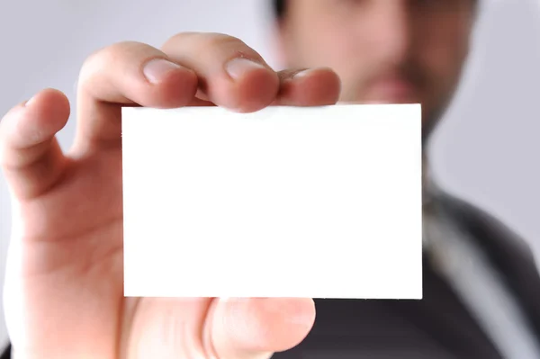 Business man handing a blank business card over white — Stock Photo, Image