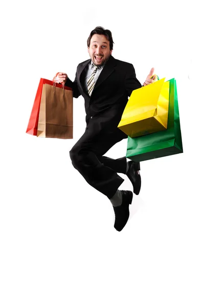 Jovem atraente empresário pulando com sacos nas mãos — Fotografia de Stock