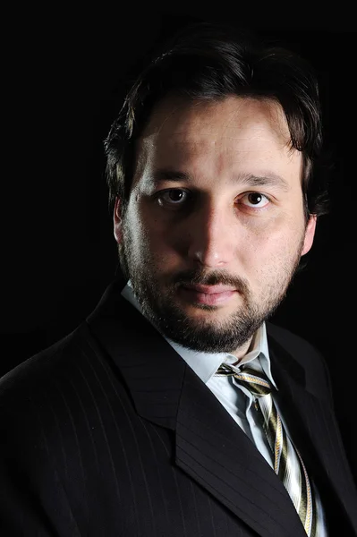 Business man portrait on black background — Stock Photo, Image