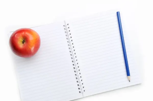 Cuaderno y manzana aislados sobre fondo blanco —  Fotos de Stock
