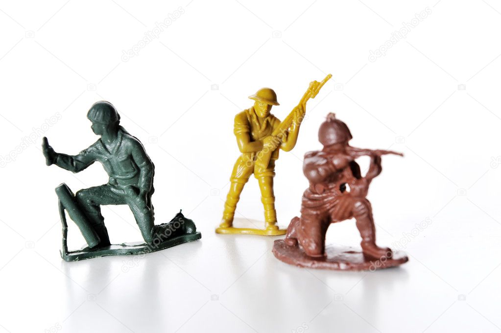 The isolated image of three green plastic toy soldiers