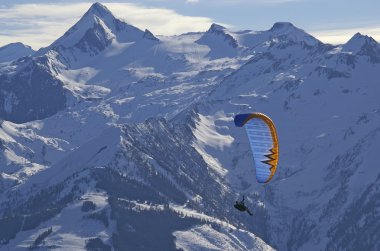 Winter paragliding in alps mountains clipart