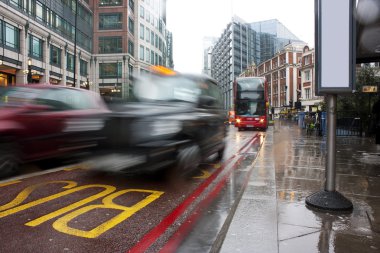 Busy london traffic in the pouring rain clipart