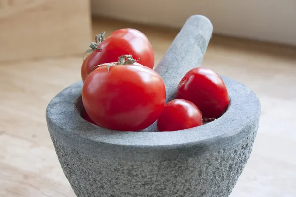 Tomatos in a pestle and mortar — Zdjęcie stockowe