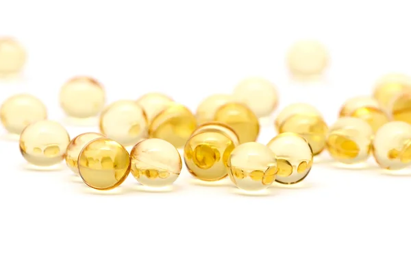 Transparent yellow capsules — Stock Photo, Image