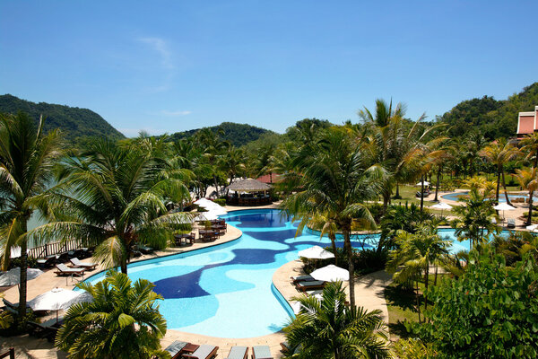 Swimming pool and garden in tropical resort