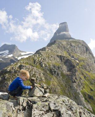 Child building a cairn clipart