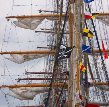 Gear of a couple of sailboats with a pirate flag clipart