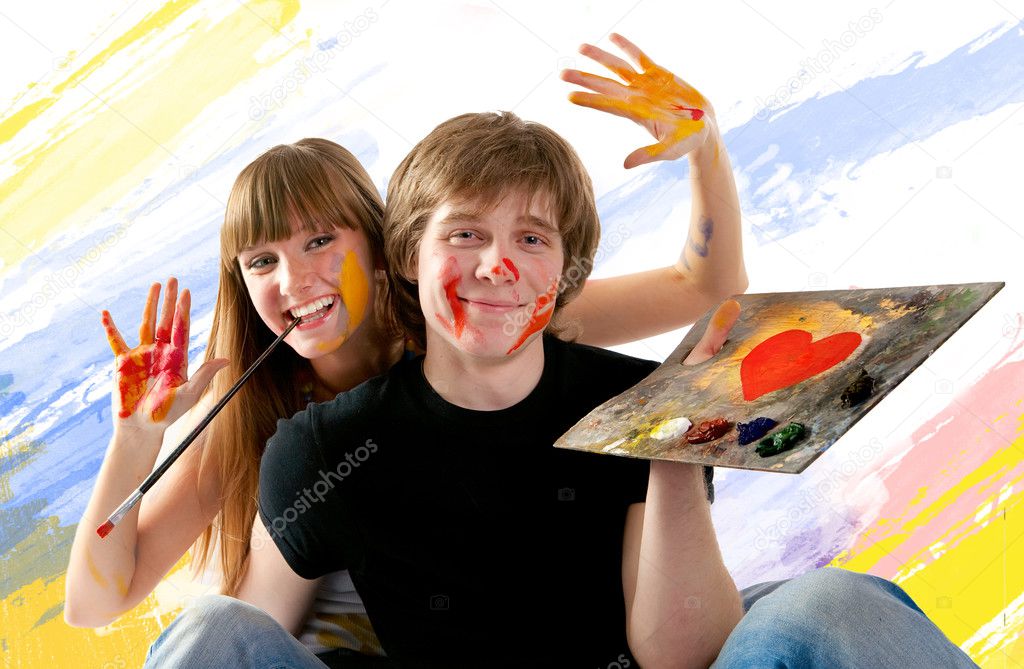 Young couple playing with painting