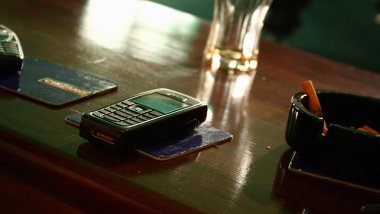 Cell phone on a desk in Club clipart