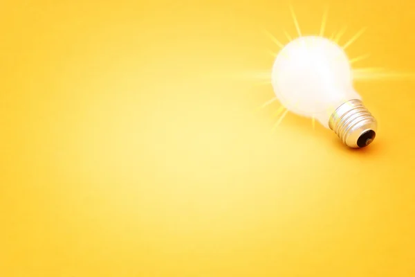 Background with lit lightbulb — Stock Photo, Image