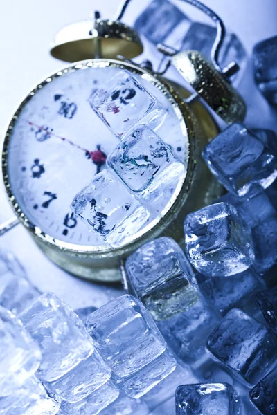 Alarm colck among ice cubes — Stock Photo, Image