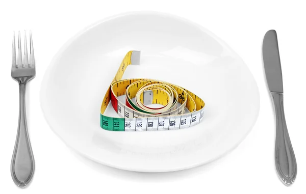 Measuring tape on white plate — Stock Photo, Image