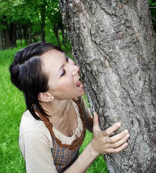 Young woman biting — Stock Photo, Image