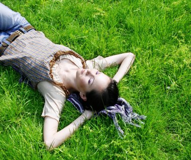 Female lying on the grass clipart