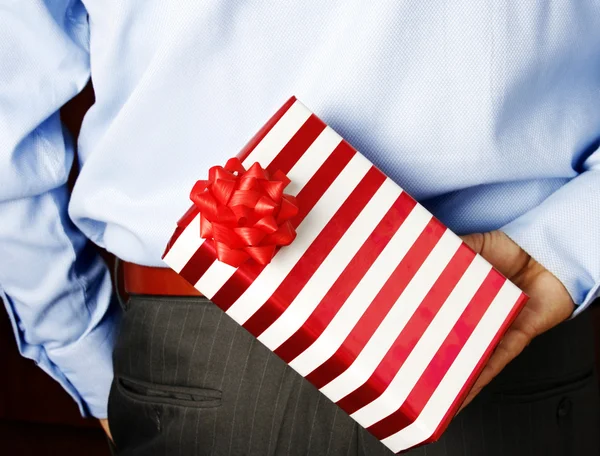 Businessman hiding a gift — Stock Photo, Image