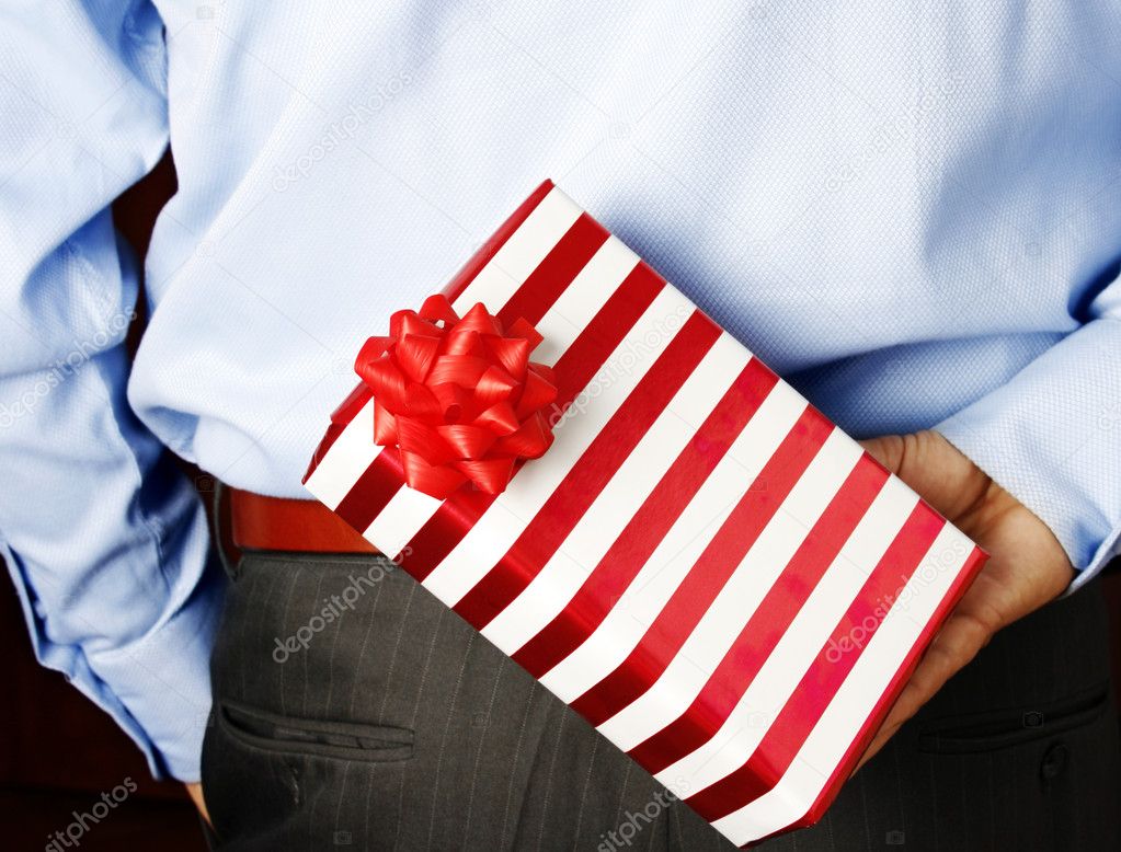 Businessman hiding a gift