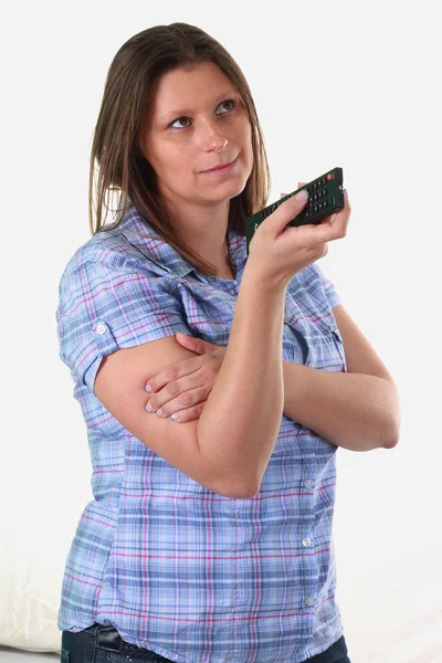Beautiful girl with remote control — Stock Photo, Image