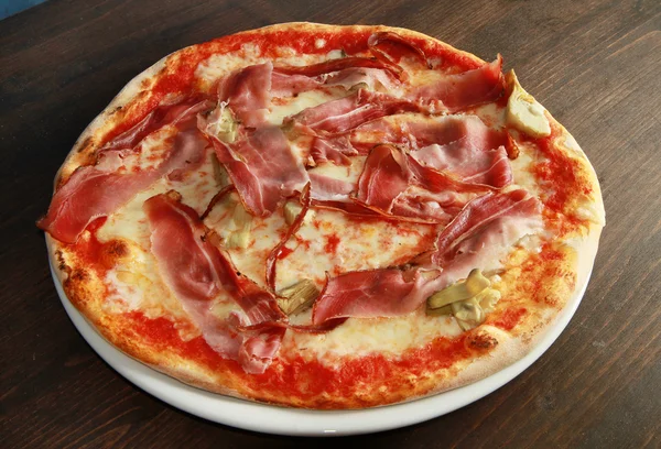 stock image Pizza on wooden table