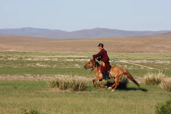 Mongolian horse herdsmen on horseback — Stock Photo, Image
