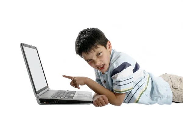 Frustrated young boy pointing at a laptop — Stock Photo, Image