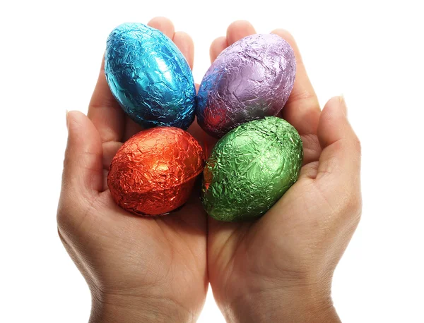 Holding four chocolate Easter eggs — Stock Photo, Image