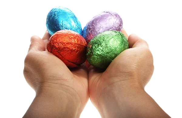 Hands holding four Easter eggs — Stock Photo, Image