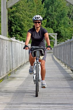 Cyclist crossing bridge clipart