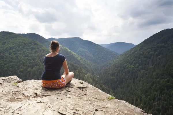 Beautiful woman meditating on big rock — Stock Photo, Image