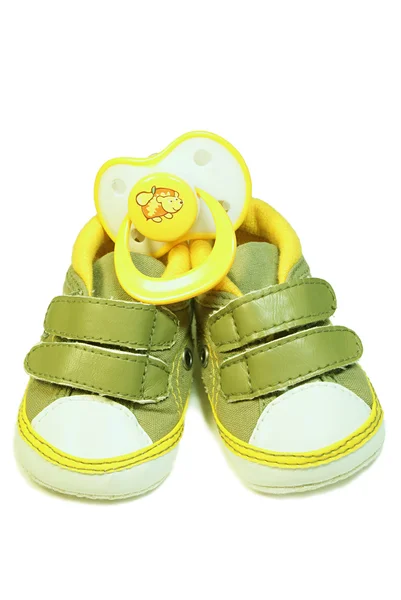 Baby’s bootee and pacifier — Stock Photo, Image